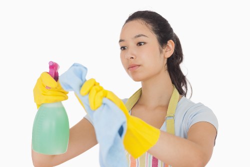 Cleaner washing glass on a residential property in W13
